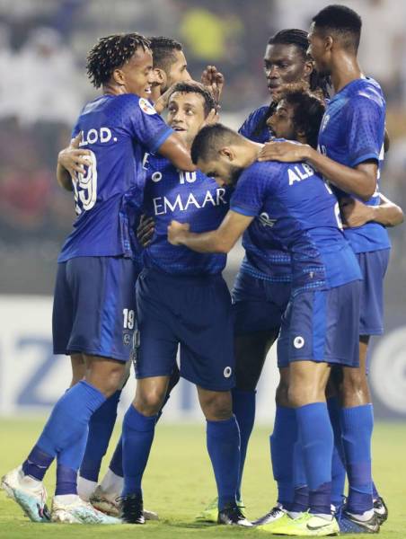 Hilal's players celebrate a goal during the first leg of the AFC Champions League semi-finals football match between Qatar's Al Sadd and Saudi' Al Hilal at the Jassim bin Hamad Stadium in the Qatari capital Doha, on October 1, 2019. / AFP / Karim JAAFAR
