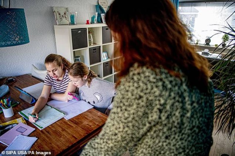 



أم أمريكية تشرف على دراسة طفلتيها في المنزل. (وكالات)
