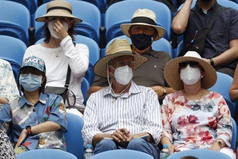 يحمون أنفسهم بالكمامات أثناء منافسات بطولة أستراليا المفتوحة لكرة المضرب في ملبورن. (وكالات)