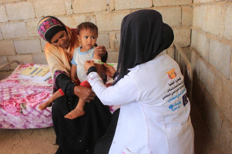 طبيبة تعالج أحد المرضى اليمنيين.