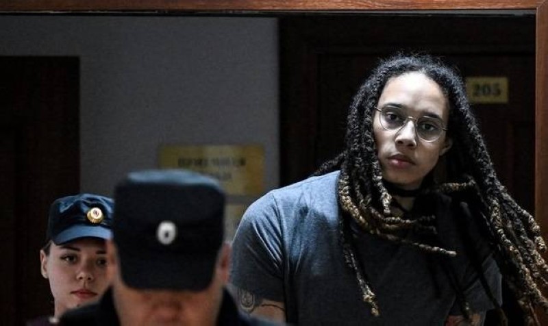 (FILES) In this file photo taken on August 4, 2022 US Women National Basketball Association's (WNBA) basketball player Brittney Griner, who was detained at Moscow's Sheremetyevo airport and later charged with illegal possession of cannabis, is escorted to the courtroom to hear the court's final decision in Khimki outside Moscow. - Moscow confirmed on December 8, 2022 it had exchanged US basketball star Brittney Griner, who had been jailed in Russia, for notorious arms trafficker Victor Bout who was serving a 25-year sentence in the United States. (Photo by Kirill KUDRYAVTSEV / AFP)