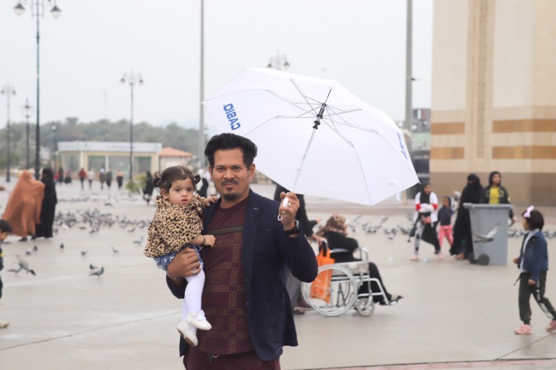 



أب في المدينة يحمي طفلته من الأمطار بالمظلة. (تصوير: بندر الترجمي)