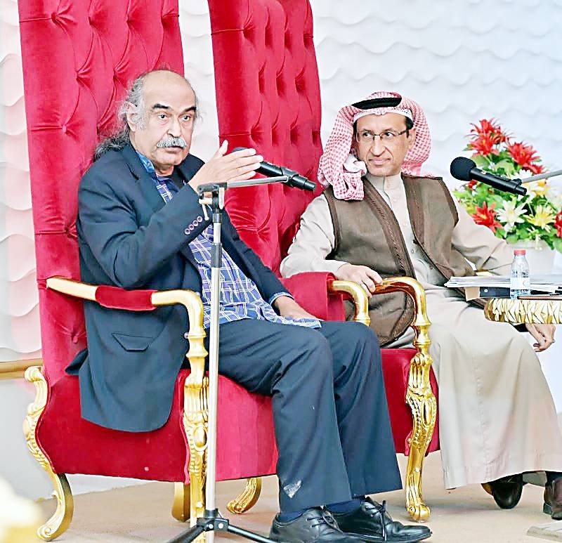 الشاعر البحريني قاسم حداد، وإلى جانبه مدير الأمسية محمد الماجد.